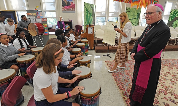Bishop Richard Malone is all smiles as he listens to the sounds of drums on the first day of school with St. Joseph University School students on Main Street, Buffalo. The seventh and eighth grade music class is led by Mrs Lynn Rezabek, pictured in the center. (Dan Cappellazzo/Staff Photographer)